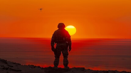 Silhouette of a soldier with drone controller at sunrise