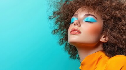 A stunning model showcasing vibrant blue eyeshadow and bold curls against a bright aqua background, exemplifying creativity and modern beauty trends in makeup artistry.
