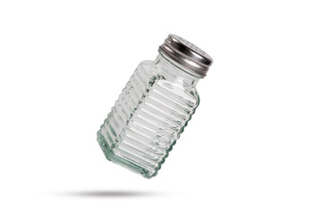 Salt shaker falling isolated on white background.