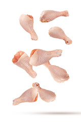 Falling raw chicken legs isolated on white background.