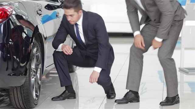 Salesman showcasing vehicle features to a customer - Powered by Adobe