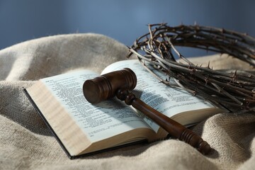 Judge's gavel, Bible and crown of thorns on burlap fabric, closeup