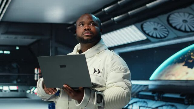 Astronaut in spacecraft using laptop to run telemetry data analysis. Man in spaceship wearing spacesuit analyzing mission logs on notebook during planetary exploration, camera B