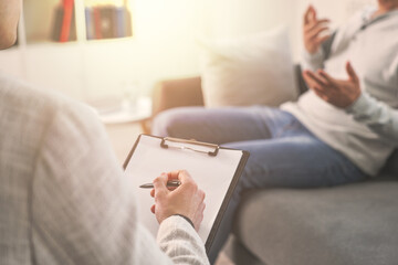 Psychologist working with client in office, closeup