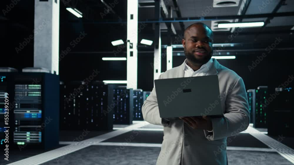 Poster data center engineer coding on laptop, doing software updates for mainframes. server farm it profess