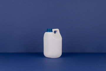 White Plastic Bottle with Blue Cap on Blue Background – Minimal Packaging Concep