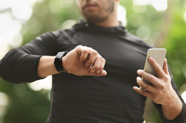 Close-up of Male Athlete Using Fitness App On His Smartwatch To Monitor Workout Performance, Crop