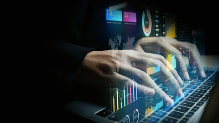 Businessperson using laptop with digital financial charts, global data analytics, and futuristic...