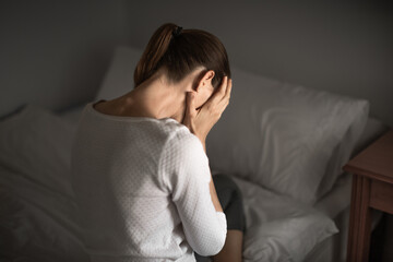 woman with hand over face suffering from depression sadness, loneliness 