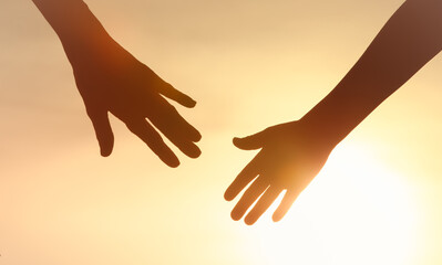 People helping each other giving a helping hand on sky sunset background, Family support, trust together, 