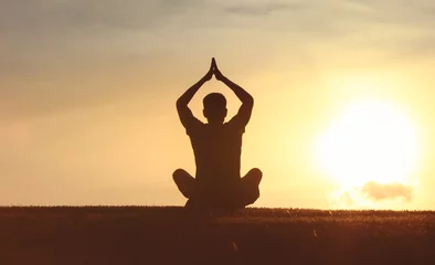  Young man meditating and practicing yoga at sunrise. Recreation, self care, yoga training, fitness, breathing exercises, meditation, relaxation, healthy lifestyle, mindfulness concept © kieferpix