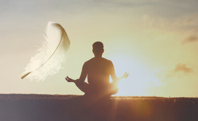 Young man meditating and practicing yoga at sunrise. Feeling light as a feather, Recreation, self care, breathing exercises, meditation, relaxation, healthy lifestyle, mindfulness concept