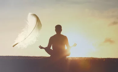  Young man meditating and practicing yoga at sunrise. Feeling light as a feather,  Recreation, self care,  breathing exercises, meditation, relaxation, healthy lifestyle, mindfulness concept © kieferpix