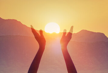 hands up to the sun at dawn, praise, worship, hope concept 
