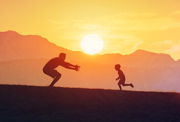 Father and son. Little boy running to his father with open arms, Happy concept of parenting and taking care of children.
