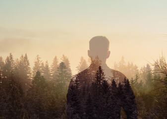 A lonely man enjoys the view of the mountain forest. Hiking and digital detox concept....