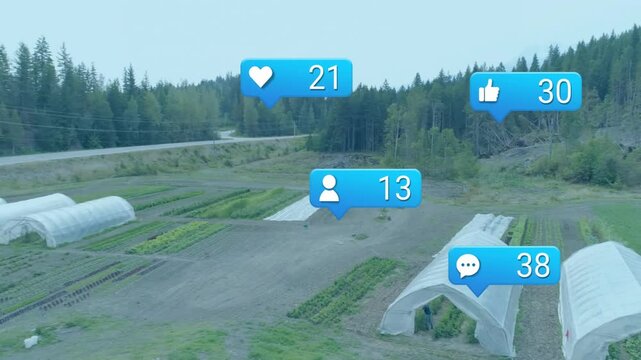 Drone revealing farm while coworkers tending seedlings in hoop house social icons rising engagement