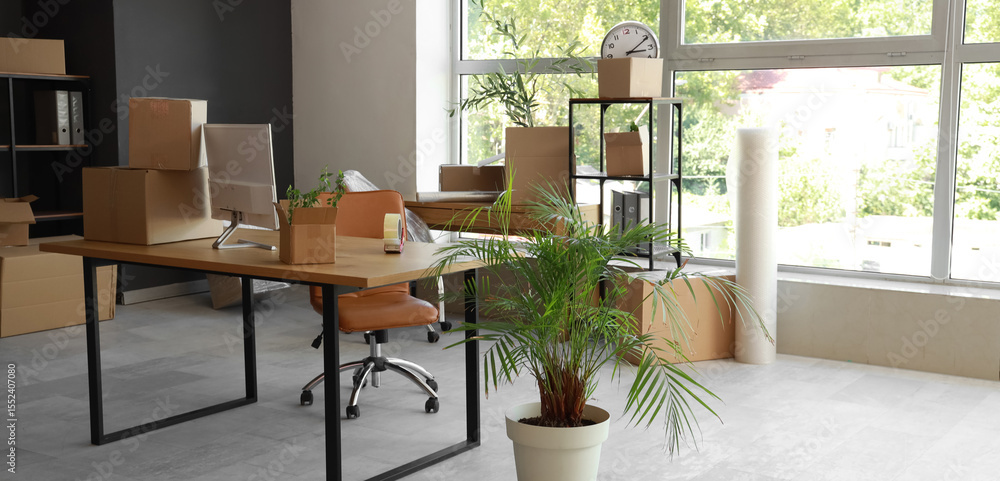 Poster modern workplace with computer monitor and cardboard boxes in office on moving day