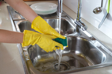 woman washing dishes in kitchen