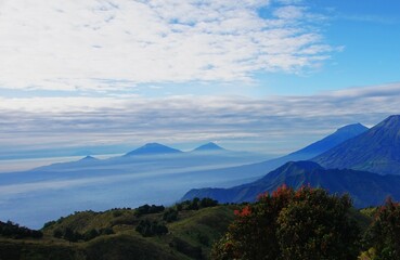 Fototapeta premium blue mountain peak with clouds and clear sky
