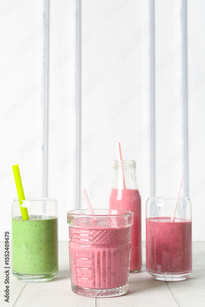 Canvas Prints glasses and bottles of colorful smoothie on white table