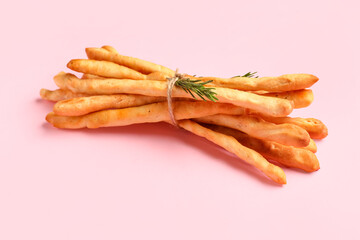 Bunch of tasty Italian Grissini on pink background
