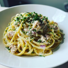 Creamy Tuna Pasta with Fresh Parsley on a White Plate
