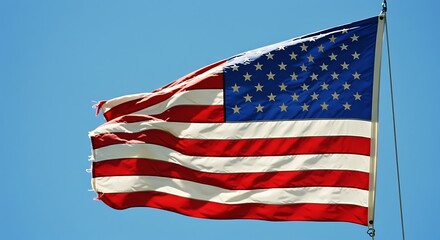 Obraz premium Waving flag against blue sky symbolizing freedom and patriotism
