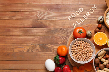 Different products with text FOOD ALLERGY on wooden background