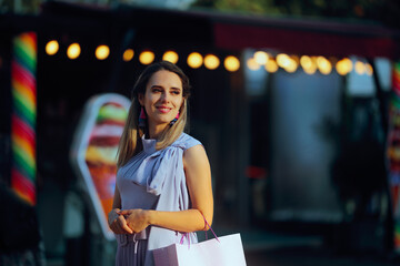 Beautiful Fashionable Woman with Shopping bag at a Funfair. Pretty lady walking on the street...