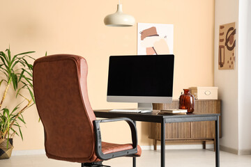 Workplace with blank computer monitor in stylish office