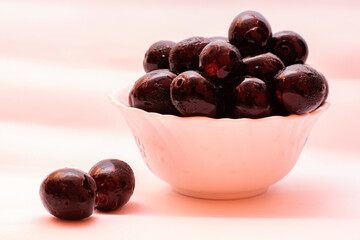 Fresh Organic Black Currants in a Small Bowl on White Background