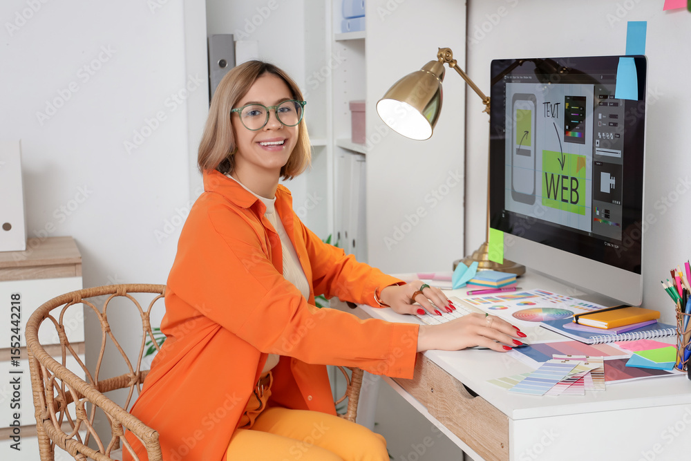 Poster female web designer working with computer at table in office