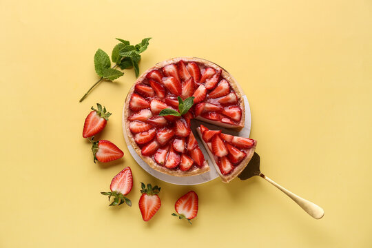 Board of cut sweet strawberry tart with mint on yellow background - Powered by Adobe