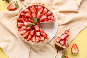 Cut sweet strawberry tart with mint on yellow background