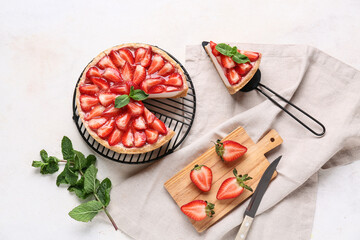 Cut sweet strawberry tart with mint and fresh berries on white background