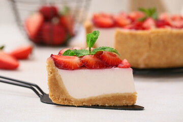Spatula with piece of sweet strawberry tart on white background, closeup