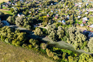 Top view of muddy water in a river near a sewage treatment plant discharge, summer cottage...
