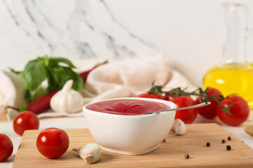 Bowl of tasty ketchup and different ingredients on white background