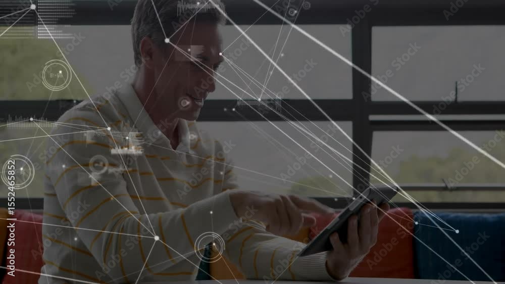 Poster man sitting on sofa holding tablet looking down updating data network overlays exploring insights