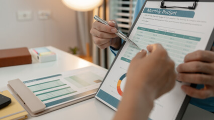 the company's auditing staff is checking the documents for accuracy in the office, businessman is...