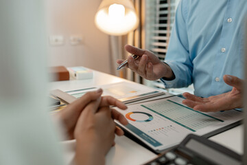 the company's auditing staff is checking the documents for accuracy in the office, businessman is...