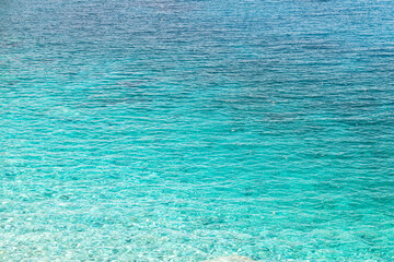 Seychelles beach at Magganitis, Ikaria island Greece, Icarian sea with crystal clear green turquoise water surface high angle above view