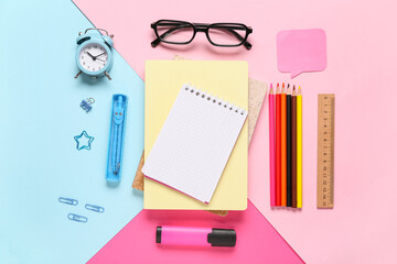 Composition with eyeglasses, alarm clock, notebooks and school supplies on color background, closeup