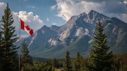 Canadian Flag with Rockie Mountains in the background during a sunny summer day. Taken in Banff National Park, Alberta, Canada. 