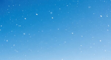 Fototapeta premium Gentle Falling Snowflakes on a Clear Blue Winter Sky Background