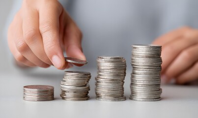 Hands adding coins to stacks of coins, rising columns made from the coins, Generative AI