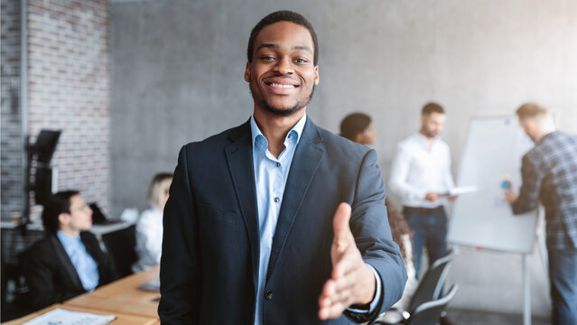 Black Businessman HR Stretching Hand For Handshake Greeting During Corporate Meeting In Modern Office, Posing Smiling To Camera. Nice To Meet You. Employment And Recruitment, Career Offer Concept