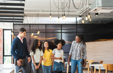 Diverse Group of Mentors and Students Walking and Talking in a Modern Space, Adult Professionals...
