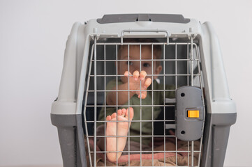 A small child in a closed cage.